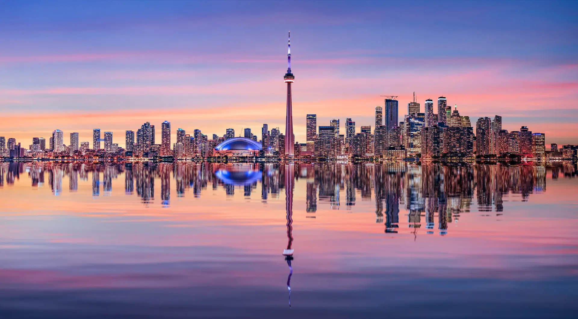 Toronto skyline at sunset seen across Lake Ontario